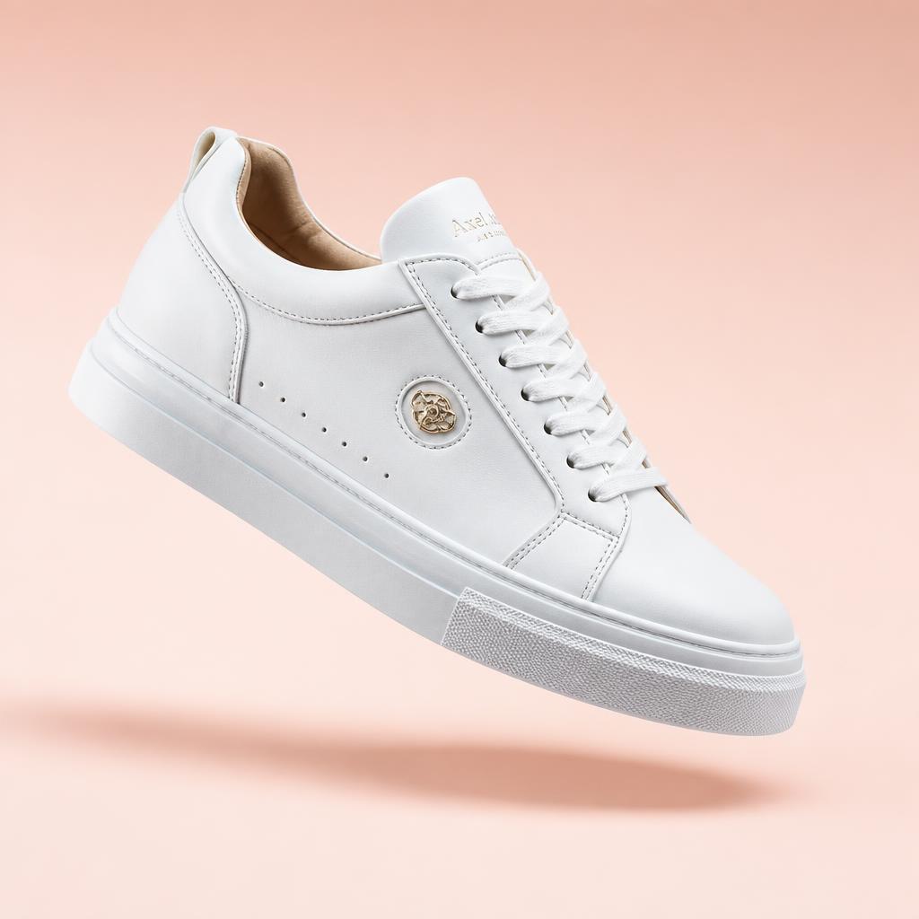 Luxury white sneaker floating on pastel peach gradient, studio strobe hero
